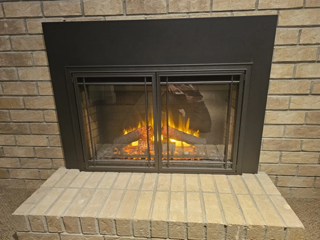 Home electric fireplace insert in brick wall