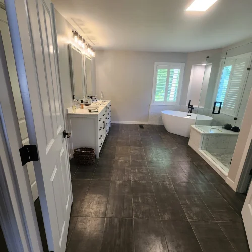 large-master-bathroom-with-dark-tile-floor-and-freestanding-tub