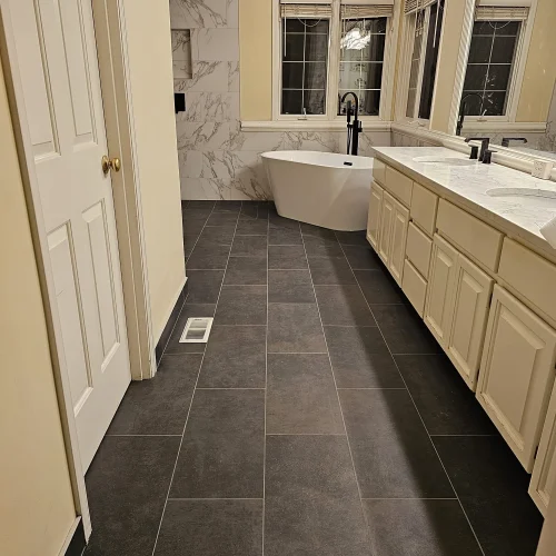 master-bathroom-with-dark-tile-floor-and-freestanding-tub
