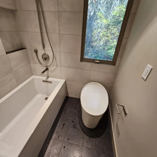 modern-bathroom-with-bathtub-shower-combo-and-toilet