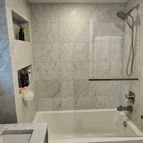 modern-bathtub-shower-combo-with-marble-tiles